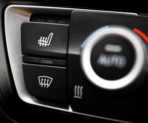 Detail of the heated seats button in a car.